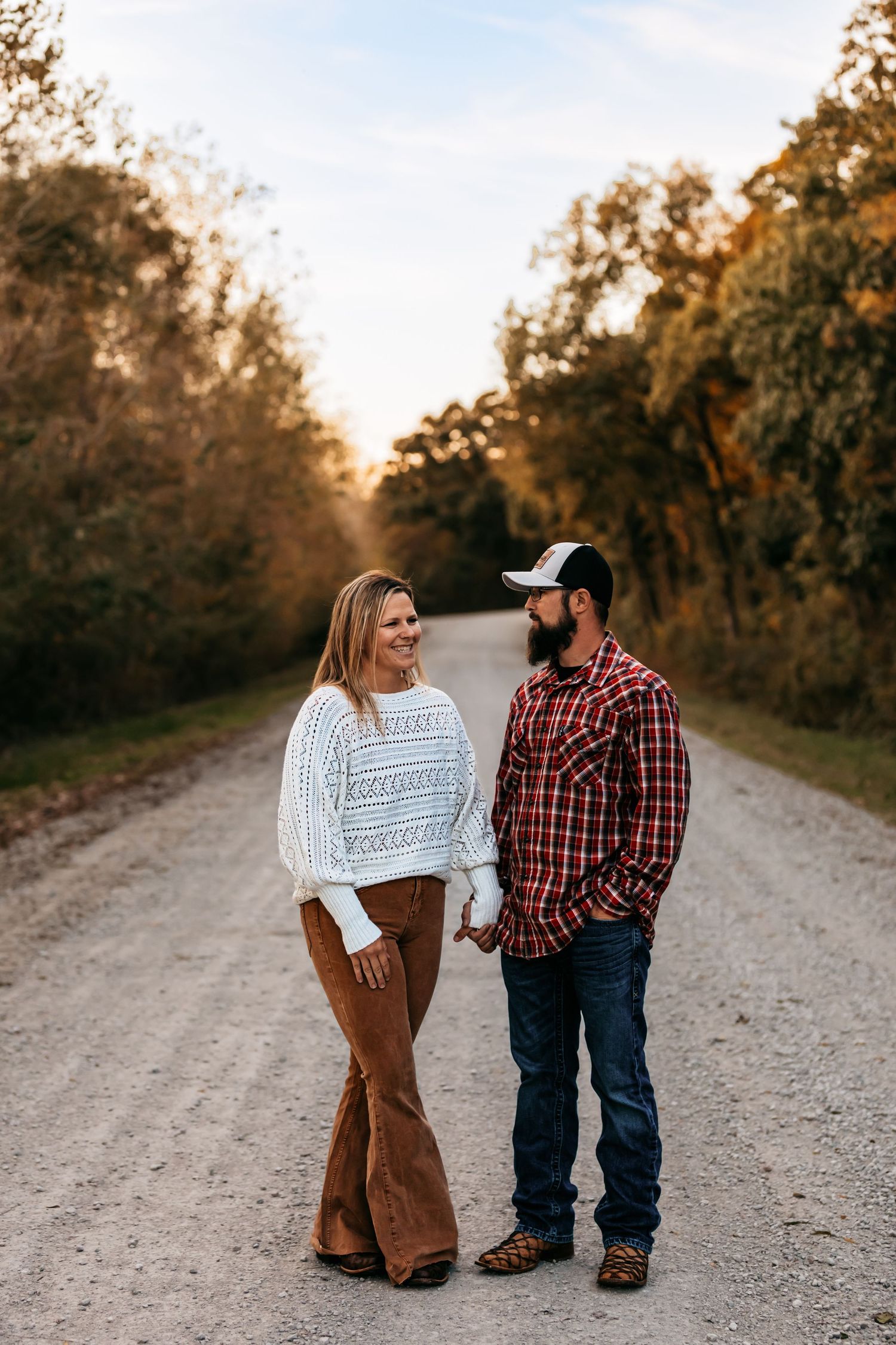 A couple on country road during golden hour in Edgerton, Missouri.
