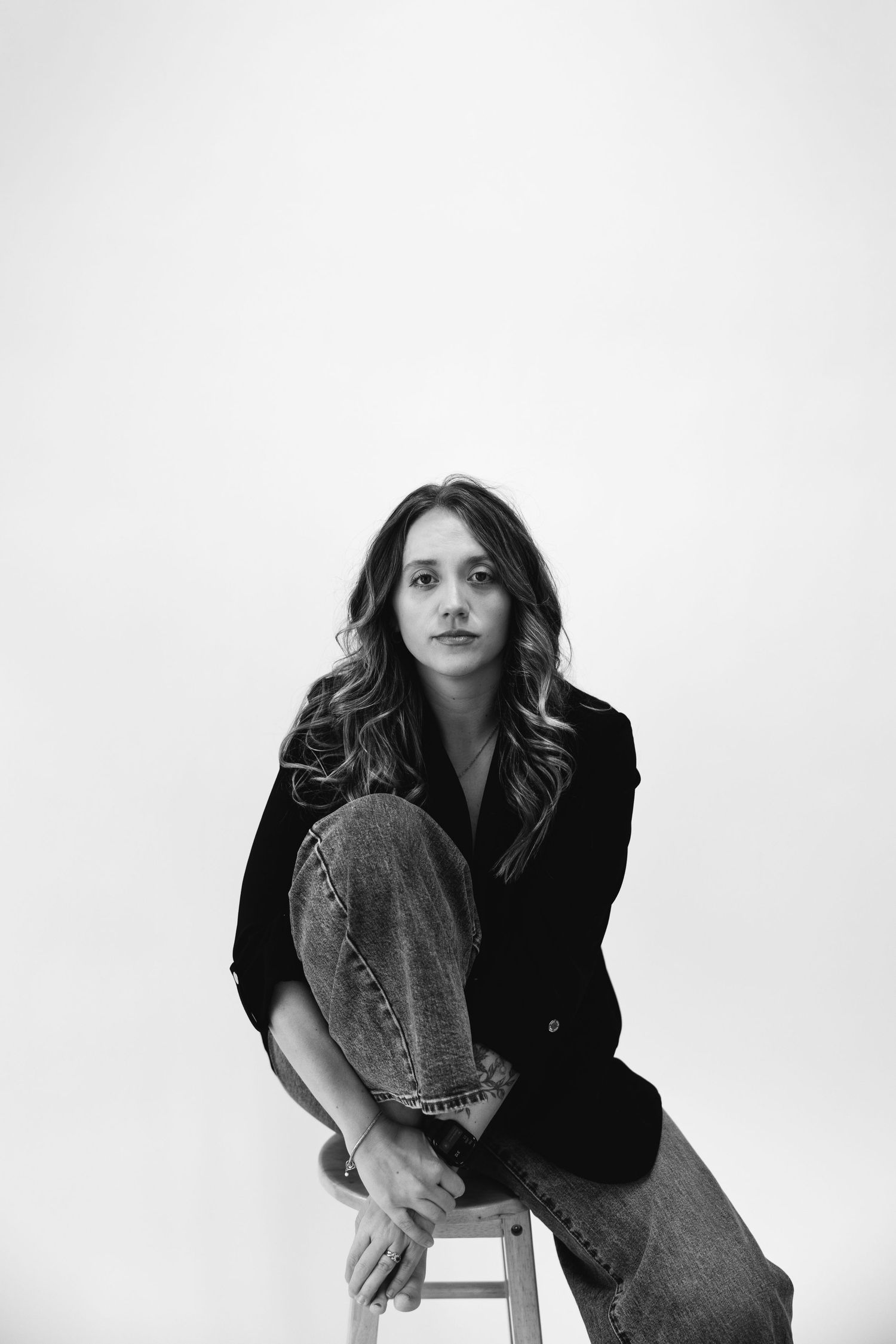 Artistic black and white portrait series against minimalist white background.