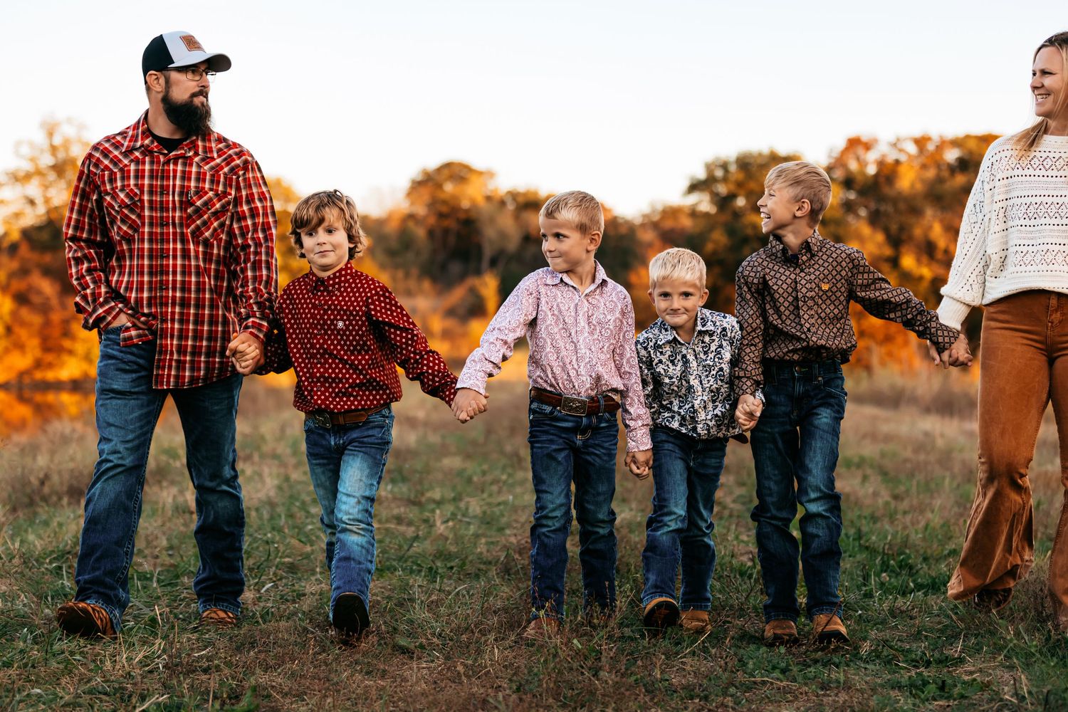 Family of six walking in a field in Edgerton, Missouri.