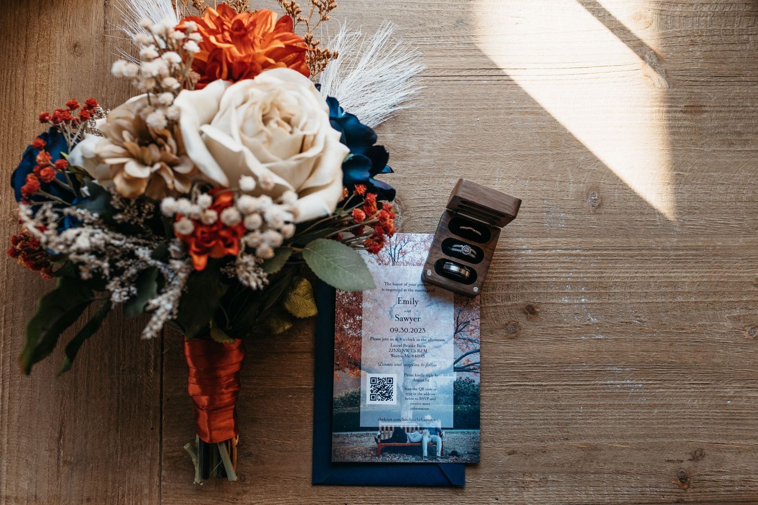 Wedding floral arrangements with coral and blue flowers displayed against wooden walls.