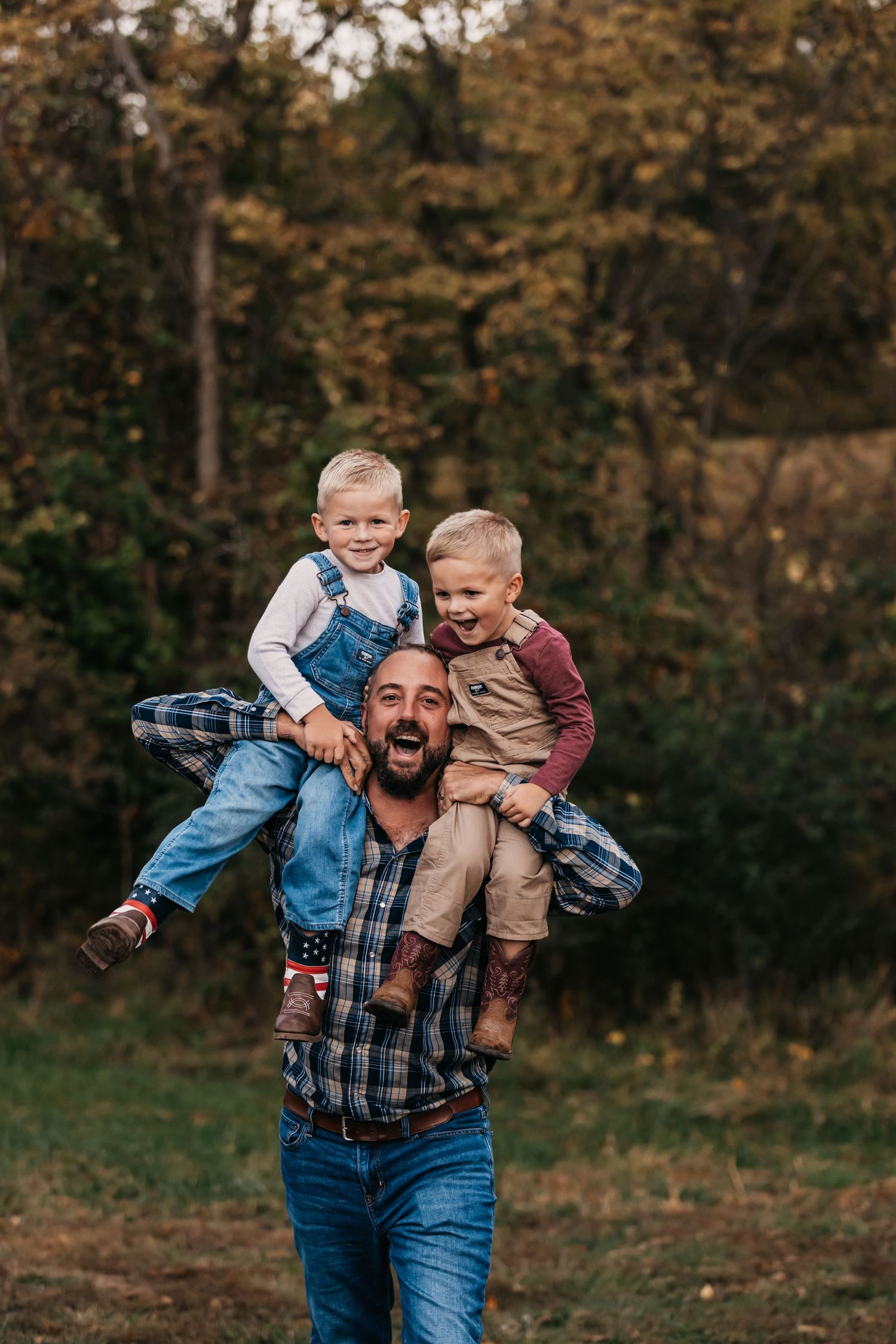 Joyful moments of someone playing and carrying children in a wooded outdoor setting.
