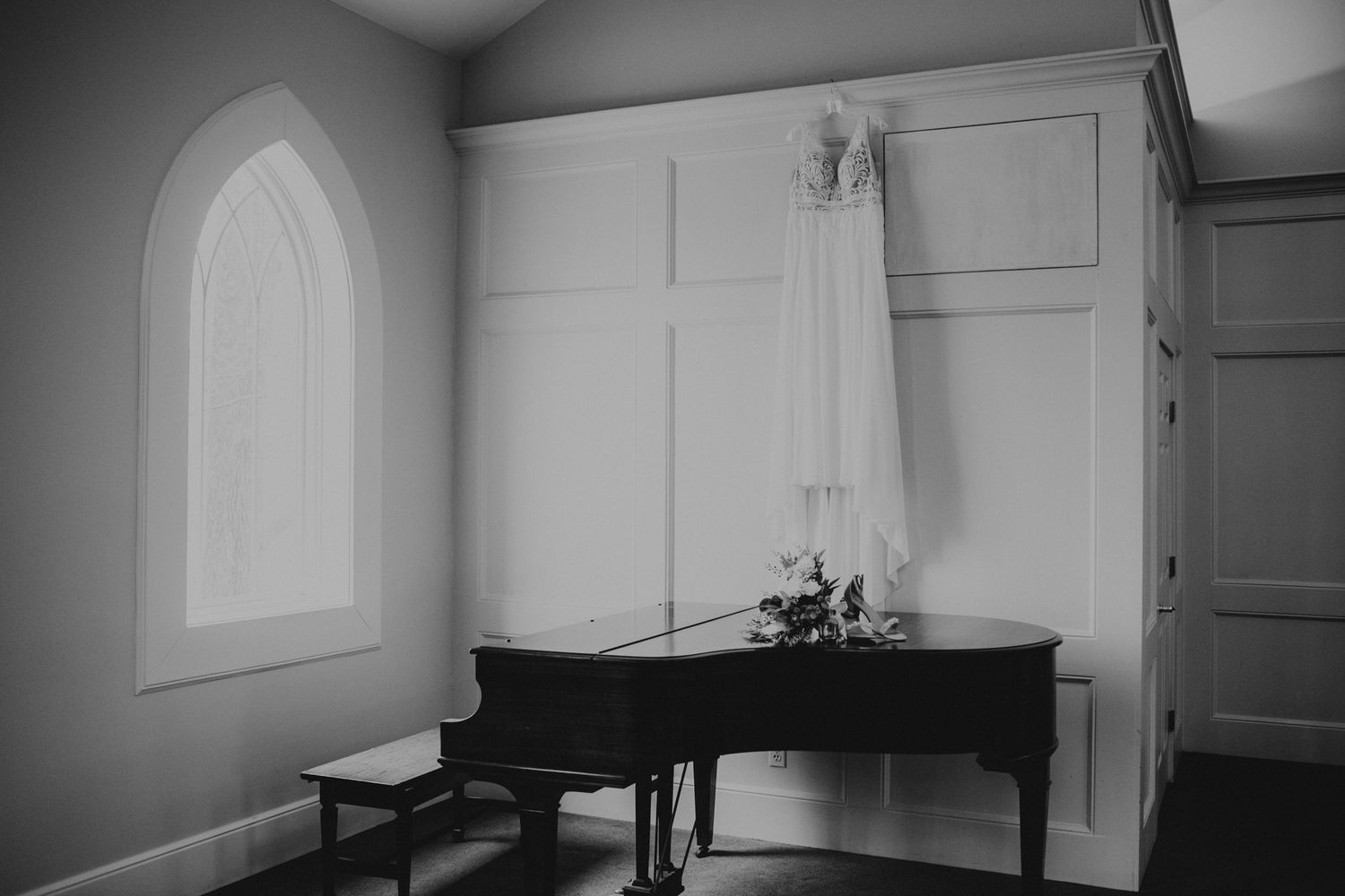 Empty church interior with arched windows and minimalist white walls.