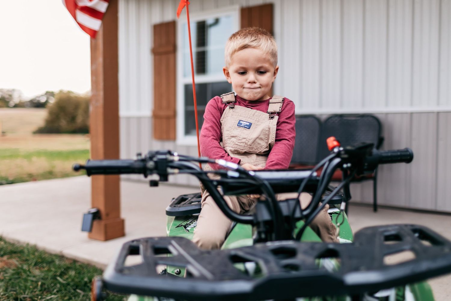 Child exploring and playing on an outdoor recreational vehicle.