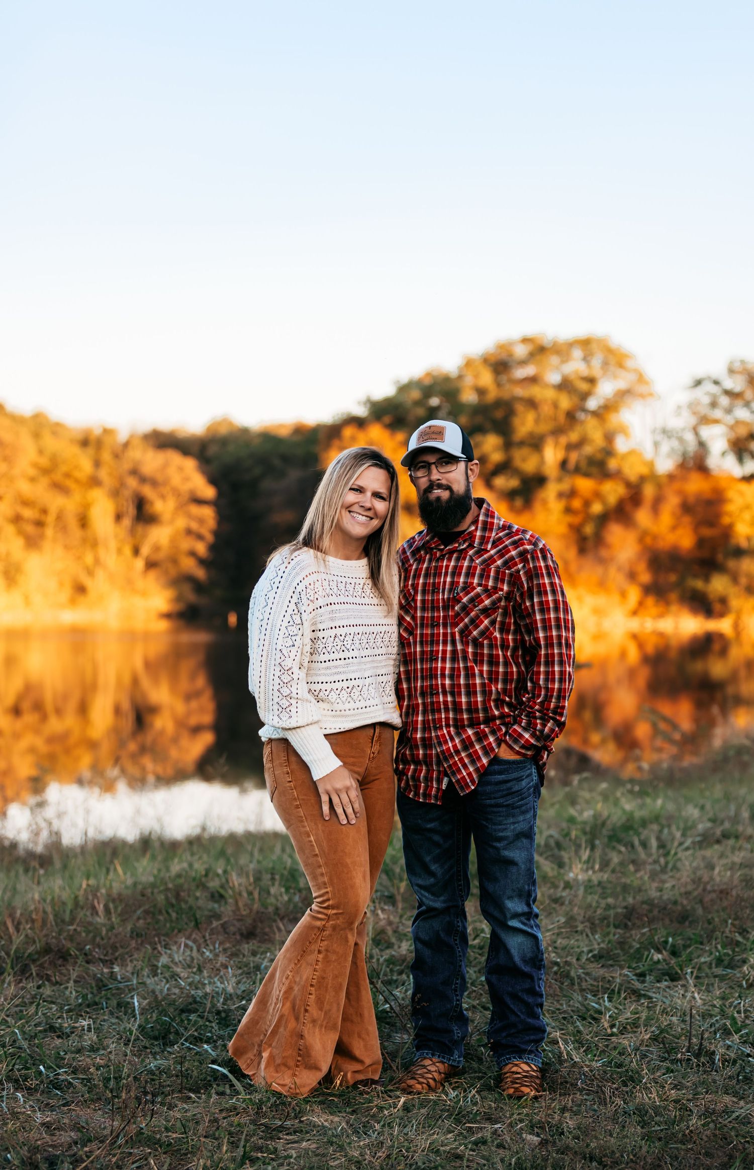 Romantic couple photos in golden sunset light with rustic autumn backdrop in Missouri