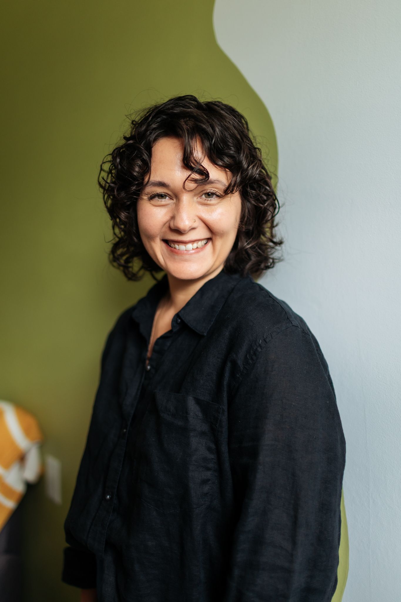 Portrait series against olive green wall showing natural expressions.