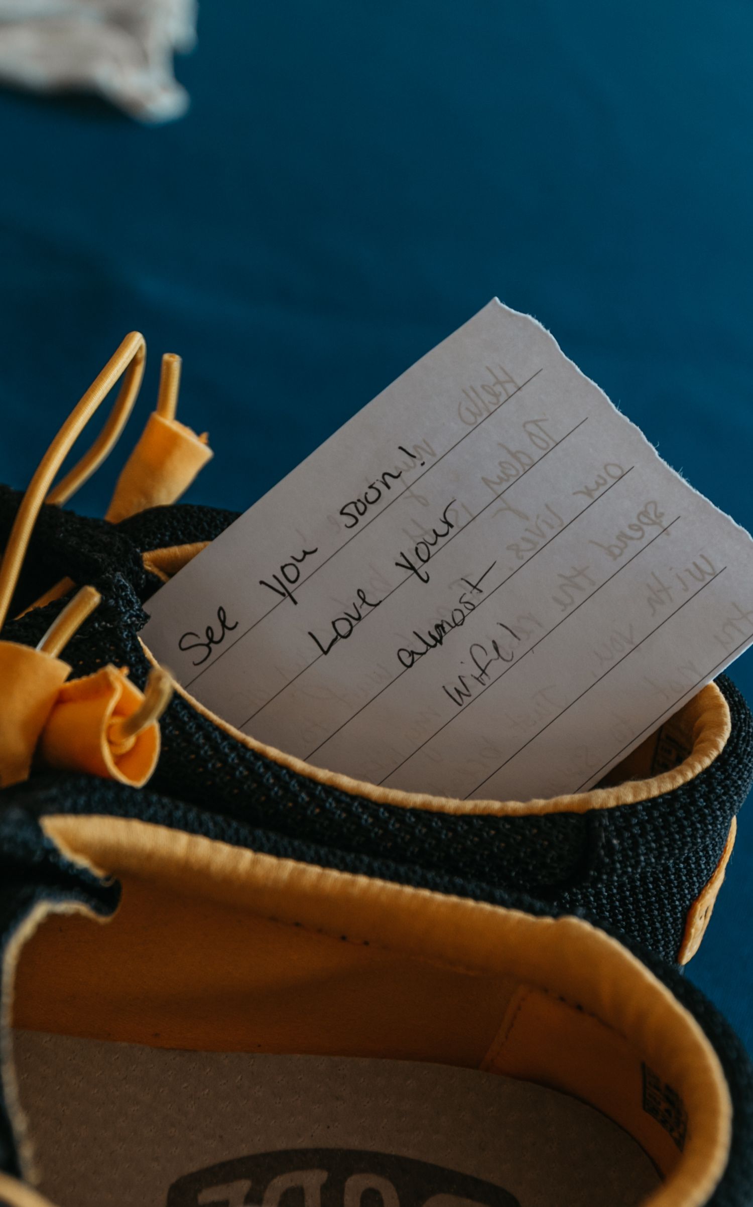 Handwritten notes tucked into a brown and black shoe.