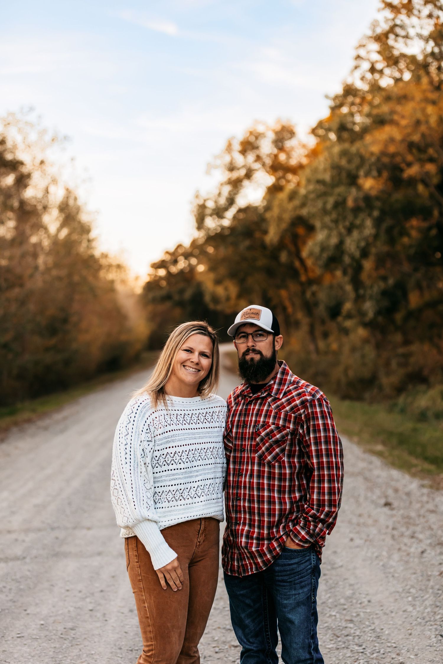 A couple on country road during golden hour in Edgerton, Missouri.