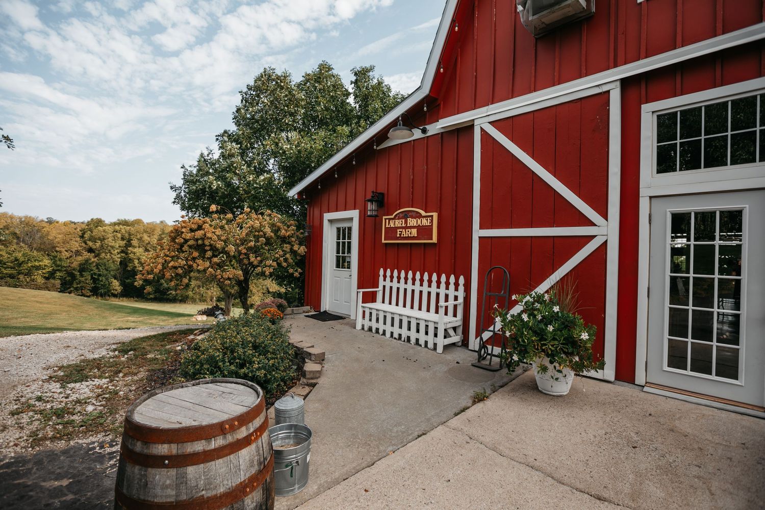 Classic red barn wedding venue exterior with white trim and rustic details.