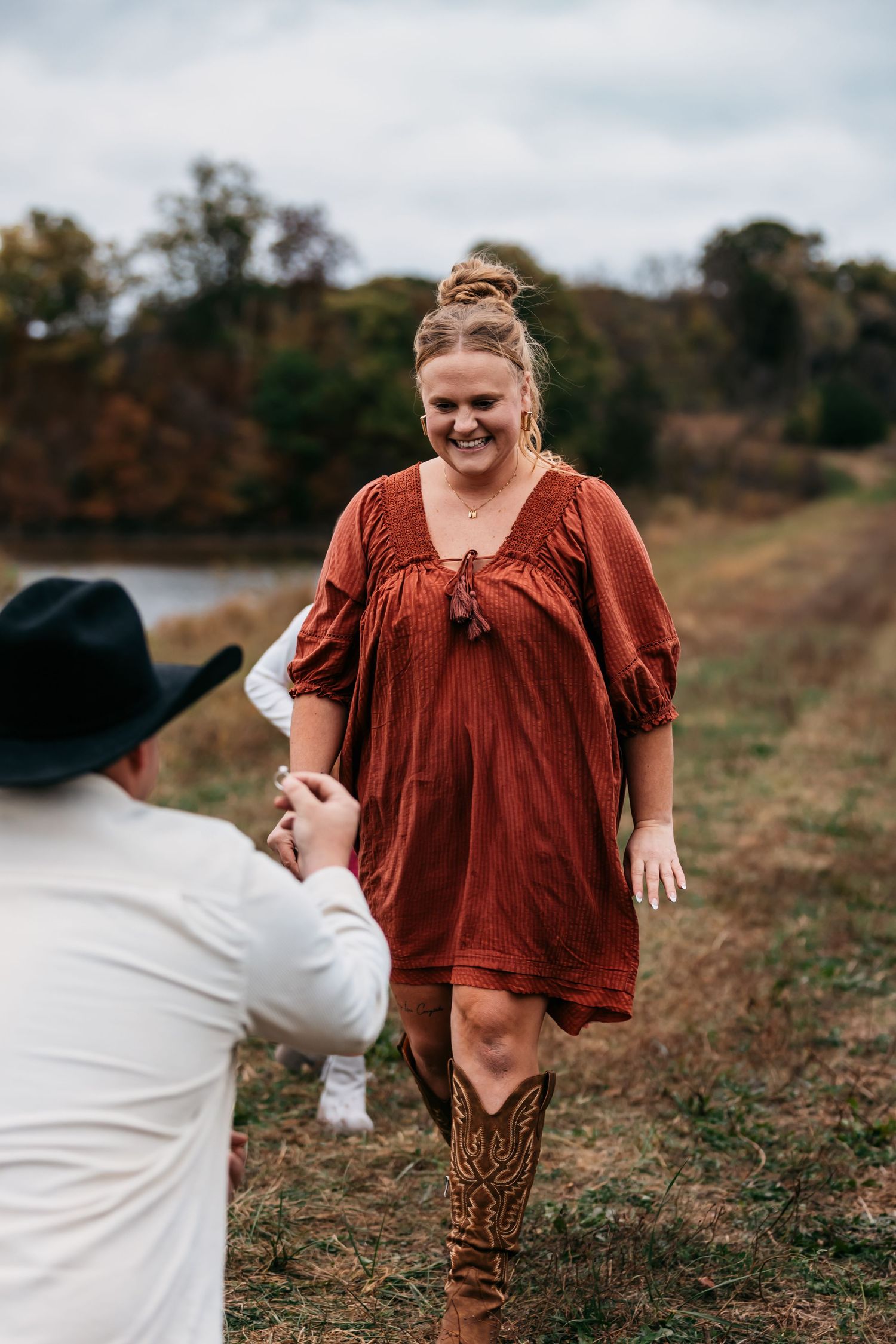 Candid outdoor photography session with joyful expressions in a rustic setting.