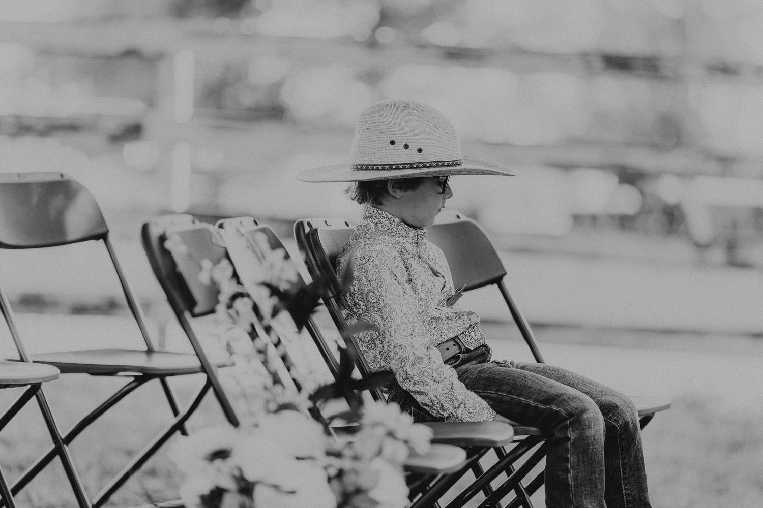 Black and white photo of vintage wooden folding chairs arranged in rows.