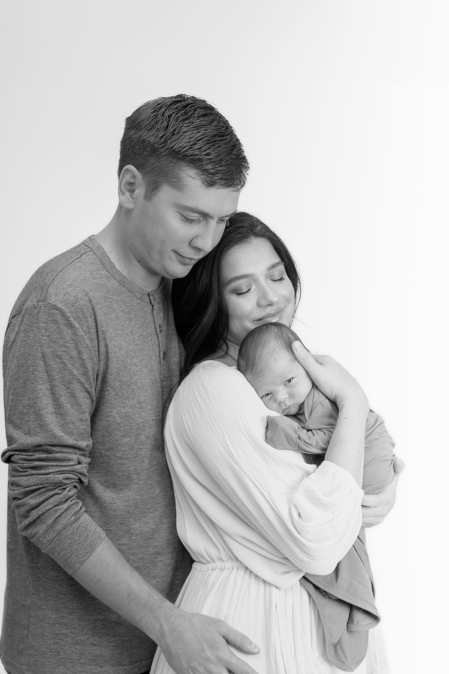 A minimalist black and white family portrait against a white background.