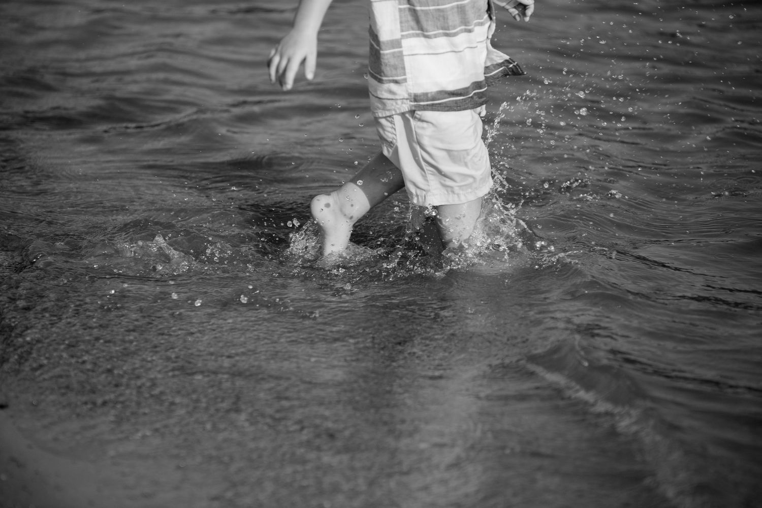 Black and white photos of people splashing and playing in water.