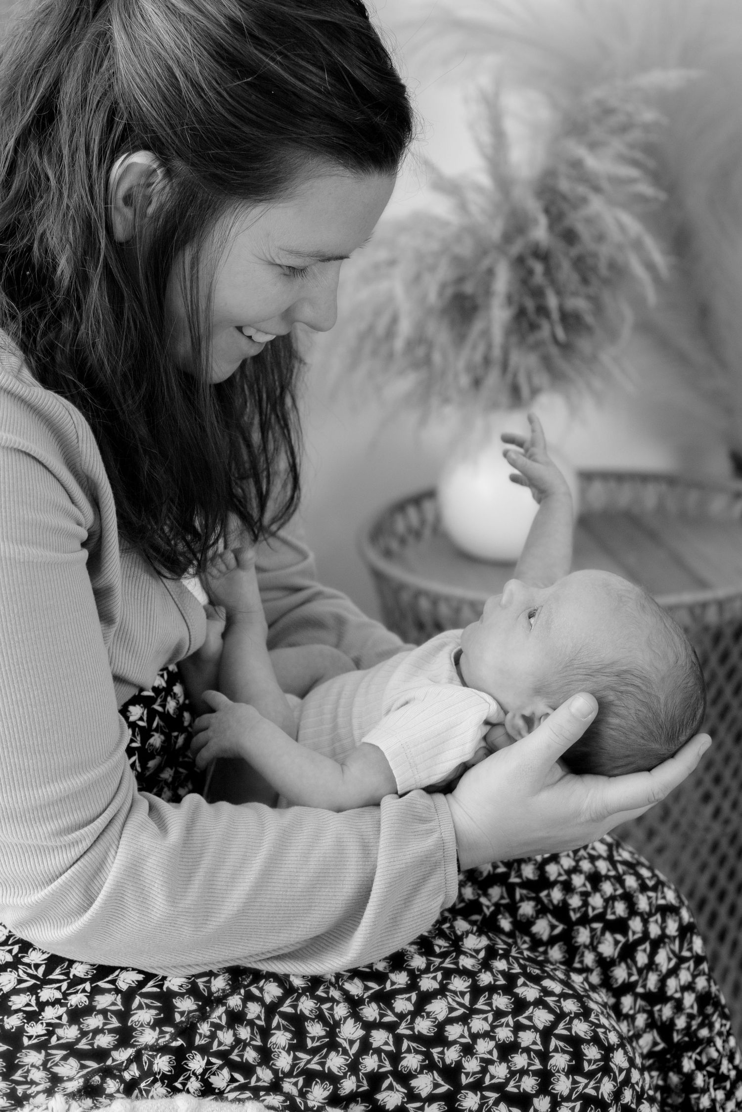 Black and white series showing tender moments between caregiver and baby in close proximity.
