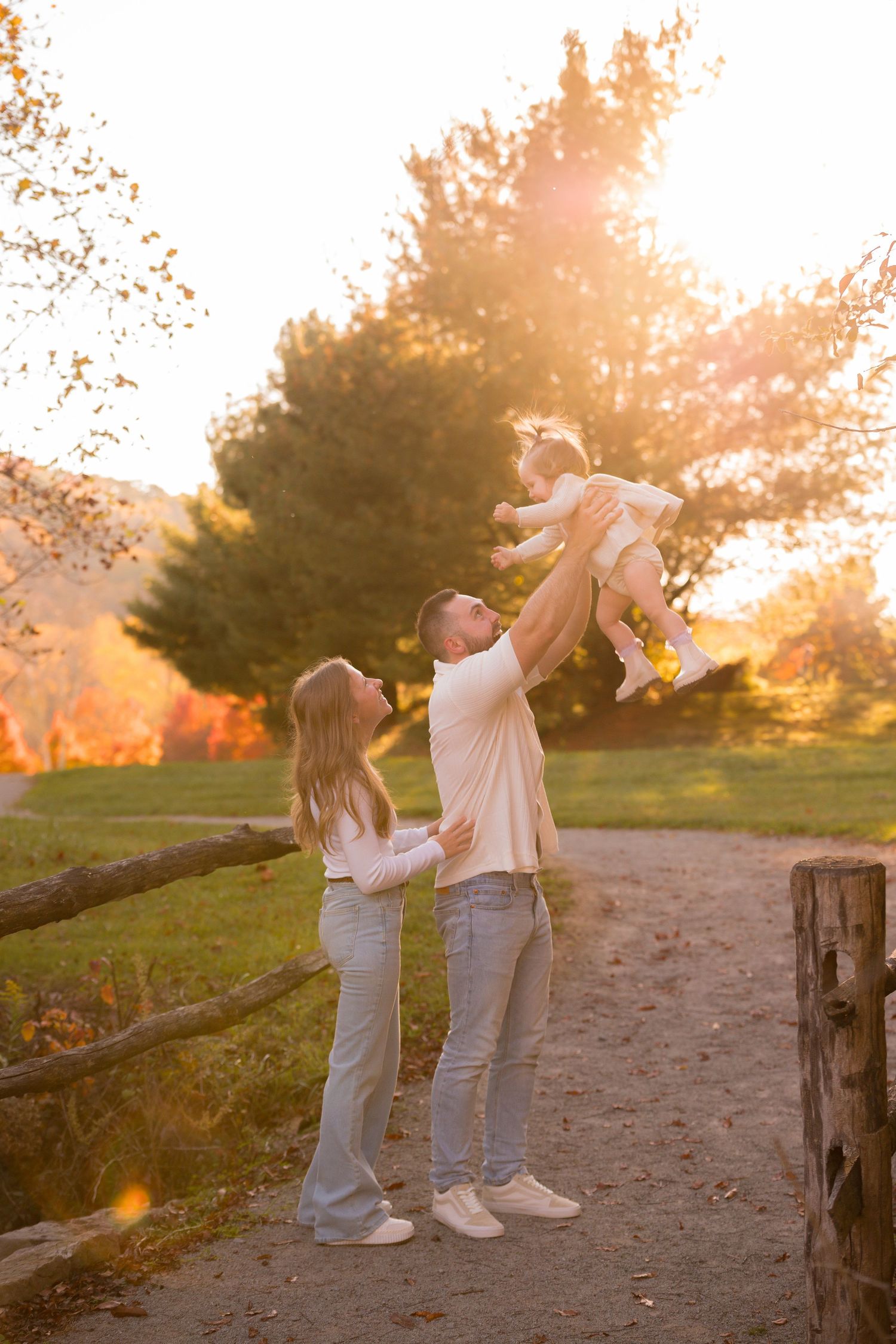 A playful scene unfolds against a golden sunset backdrop in an autumn park.