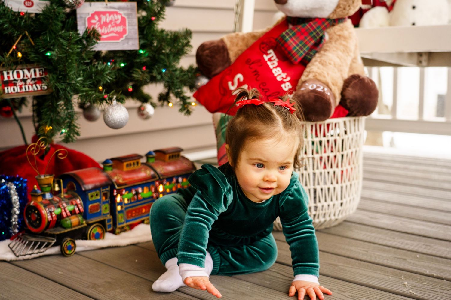 Christmas decorations and wrapped presents surround a festive holiday scene.