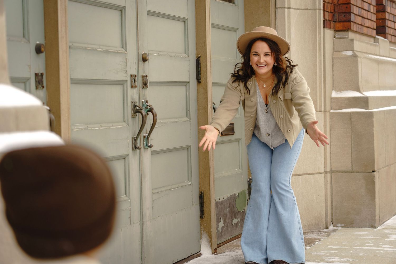 A playful sequence of poses on stone steps outside a building.