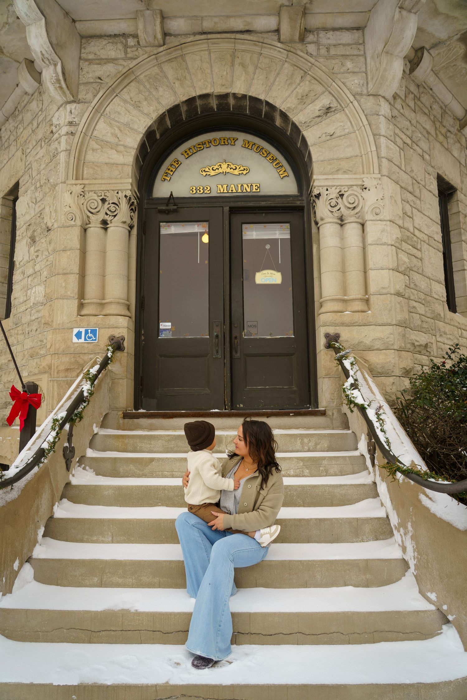 A sequence of playful poses on stone steps in front of an ornate building entrance.