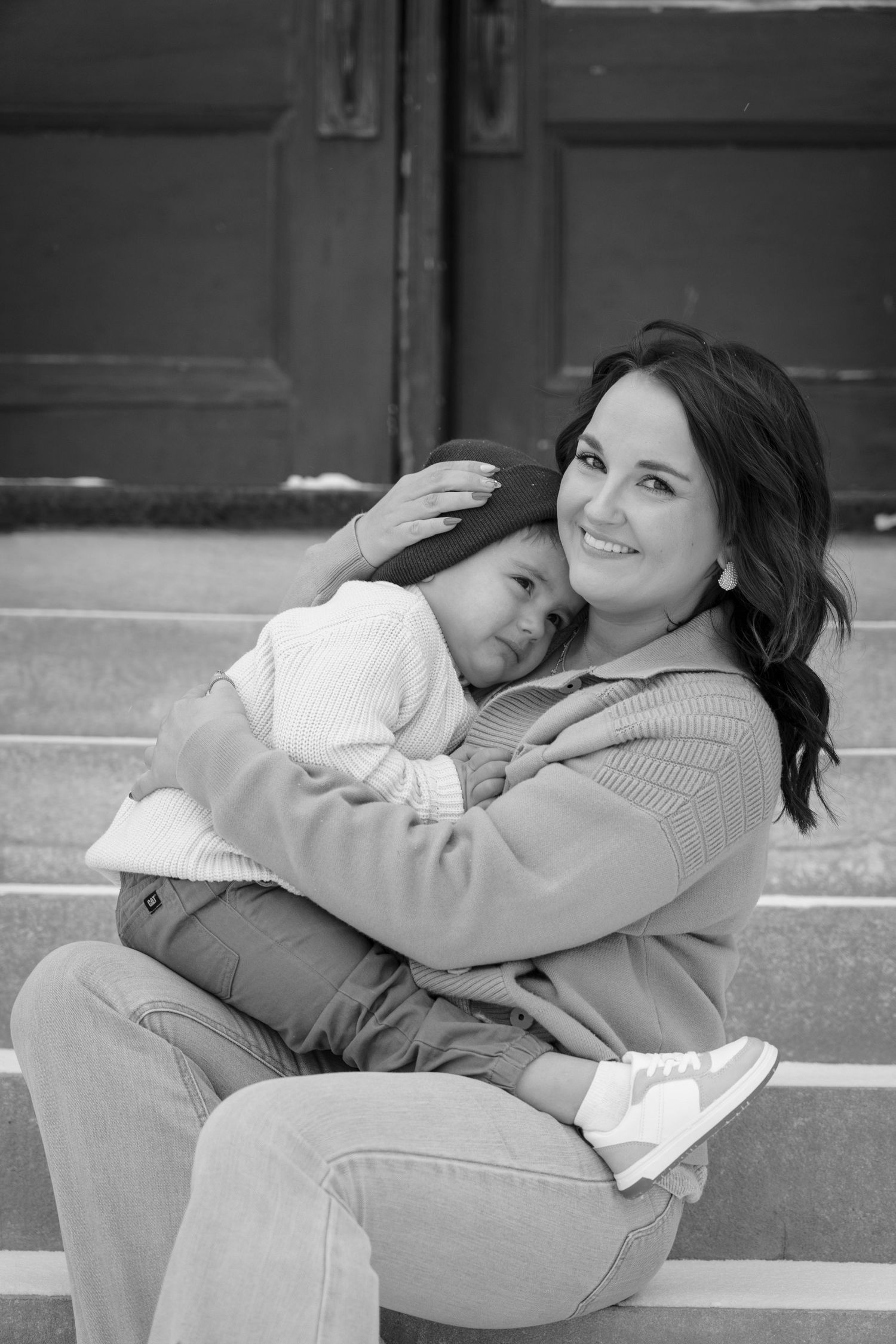 Black and white series showing a loving embrace on stone steps.