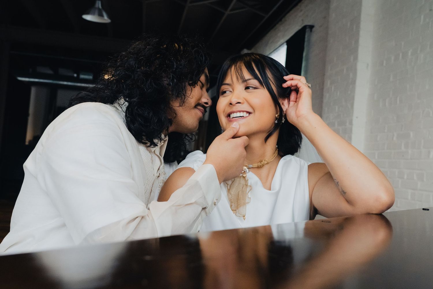 Romantic couple shares intimate moments in black and white photo series showing tender embraces and laughter.