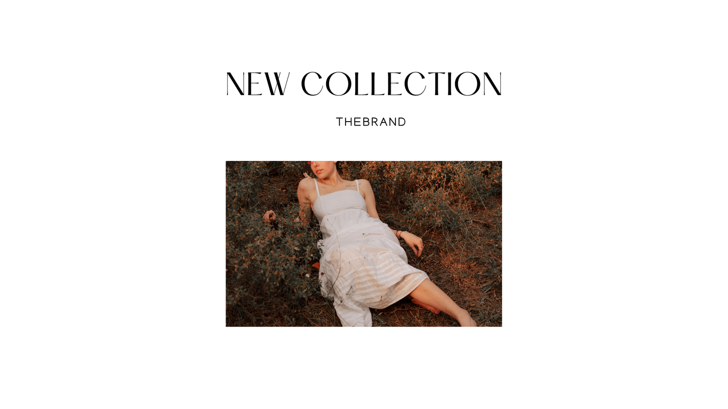 Woman in white ruffled dress lying in a field for The Brand new collection fashion campaign.
