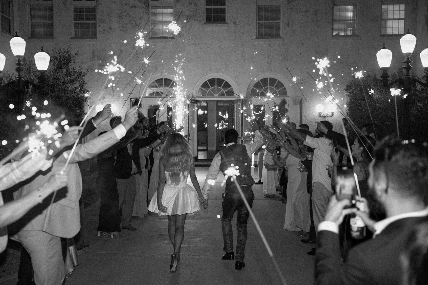 Vintage black and white photo sequence showing a group of people dancing at a formal event under glowing lanterns.