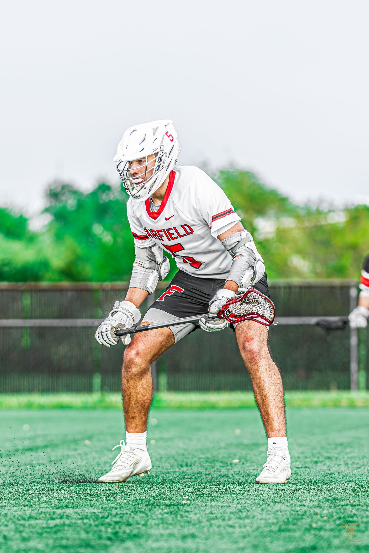 Lacrosse player getting into stance.
