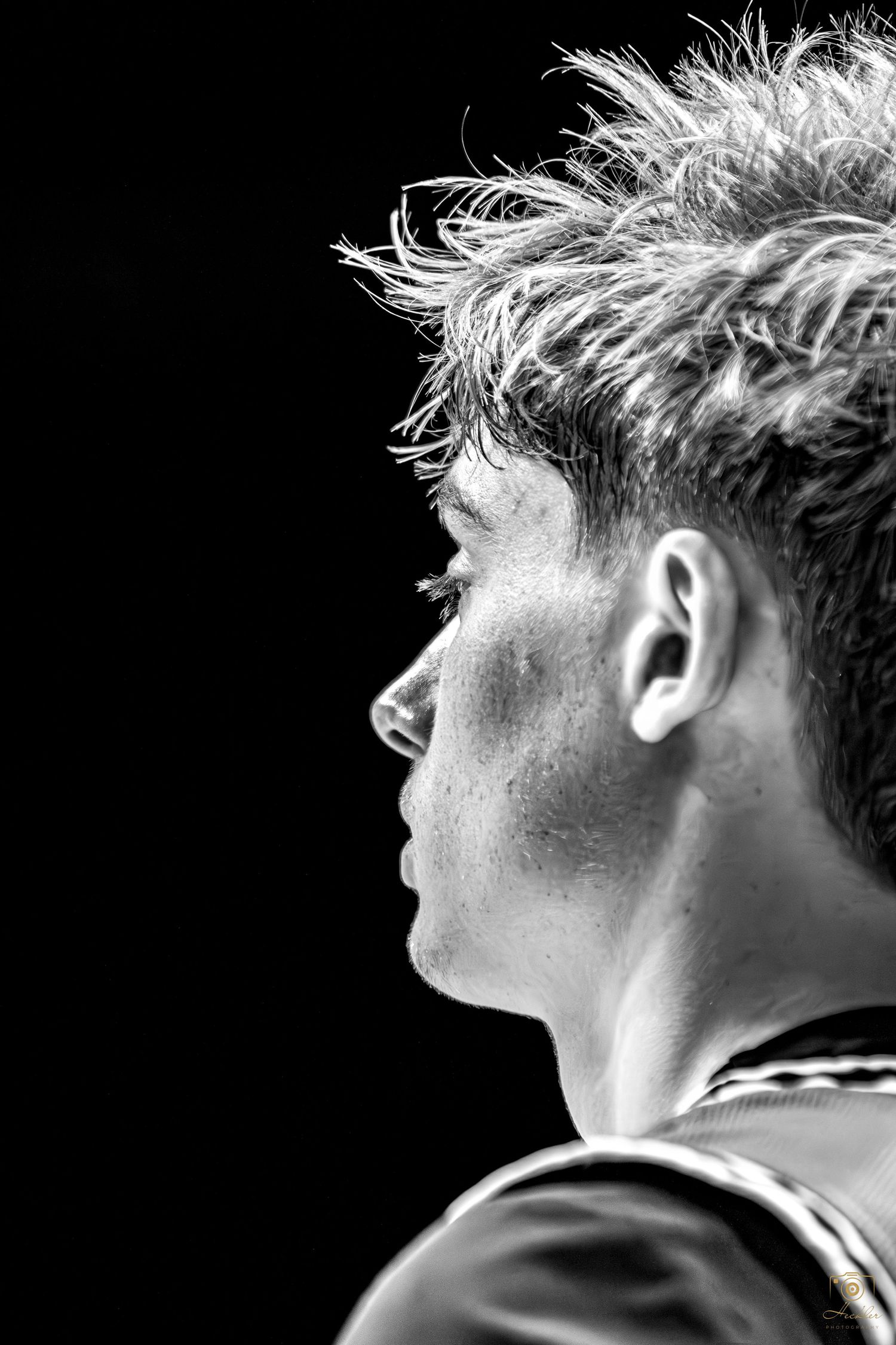 Basketball player in B&W side of face.