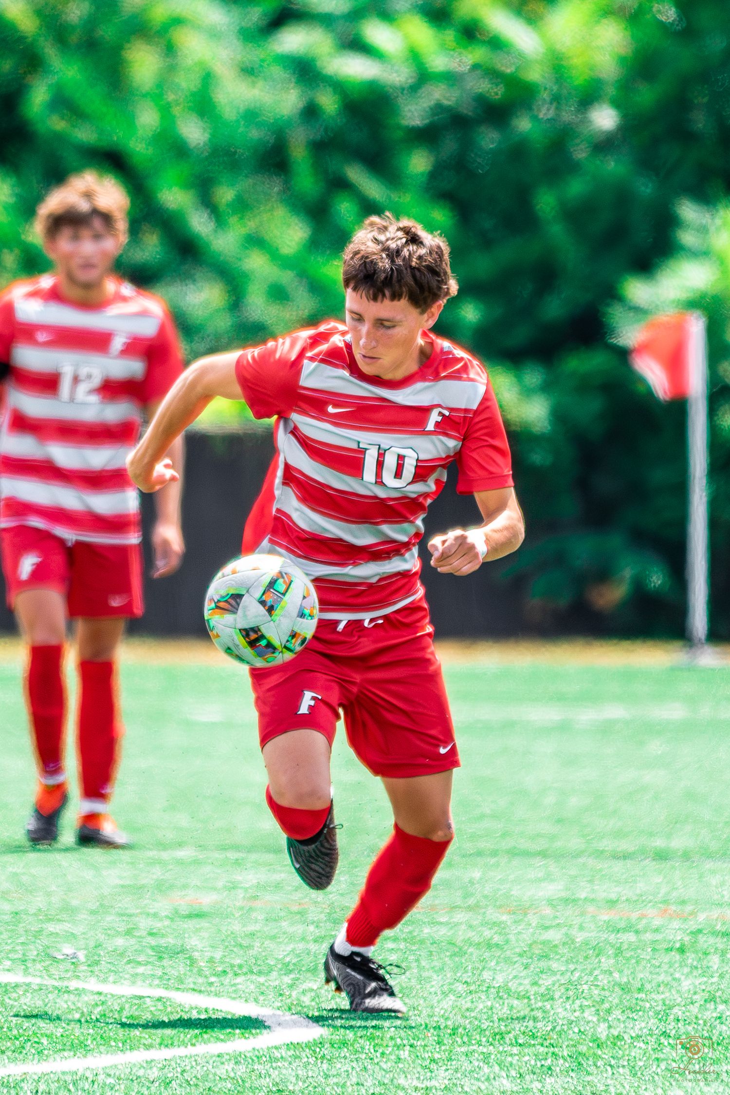 Soccer player running with ball.