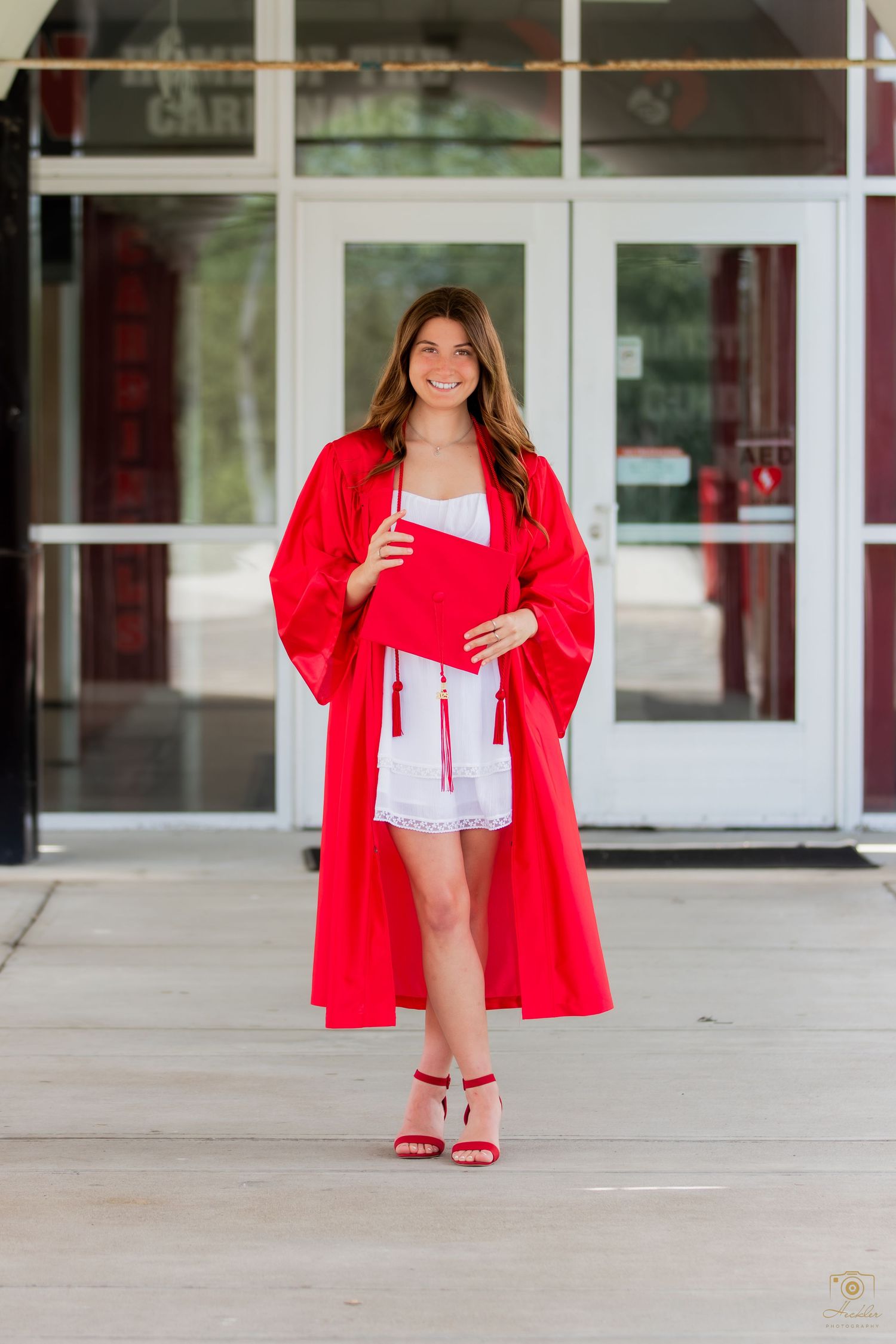 Senior with cap and gown smiling.
