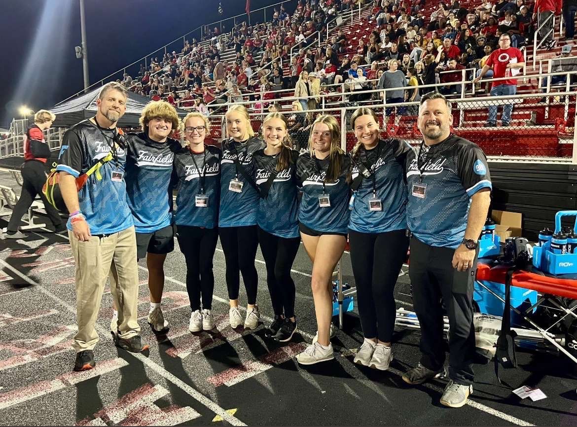 Student trainers smiling at camera.