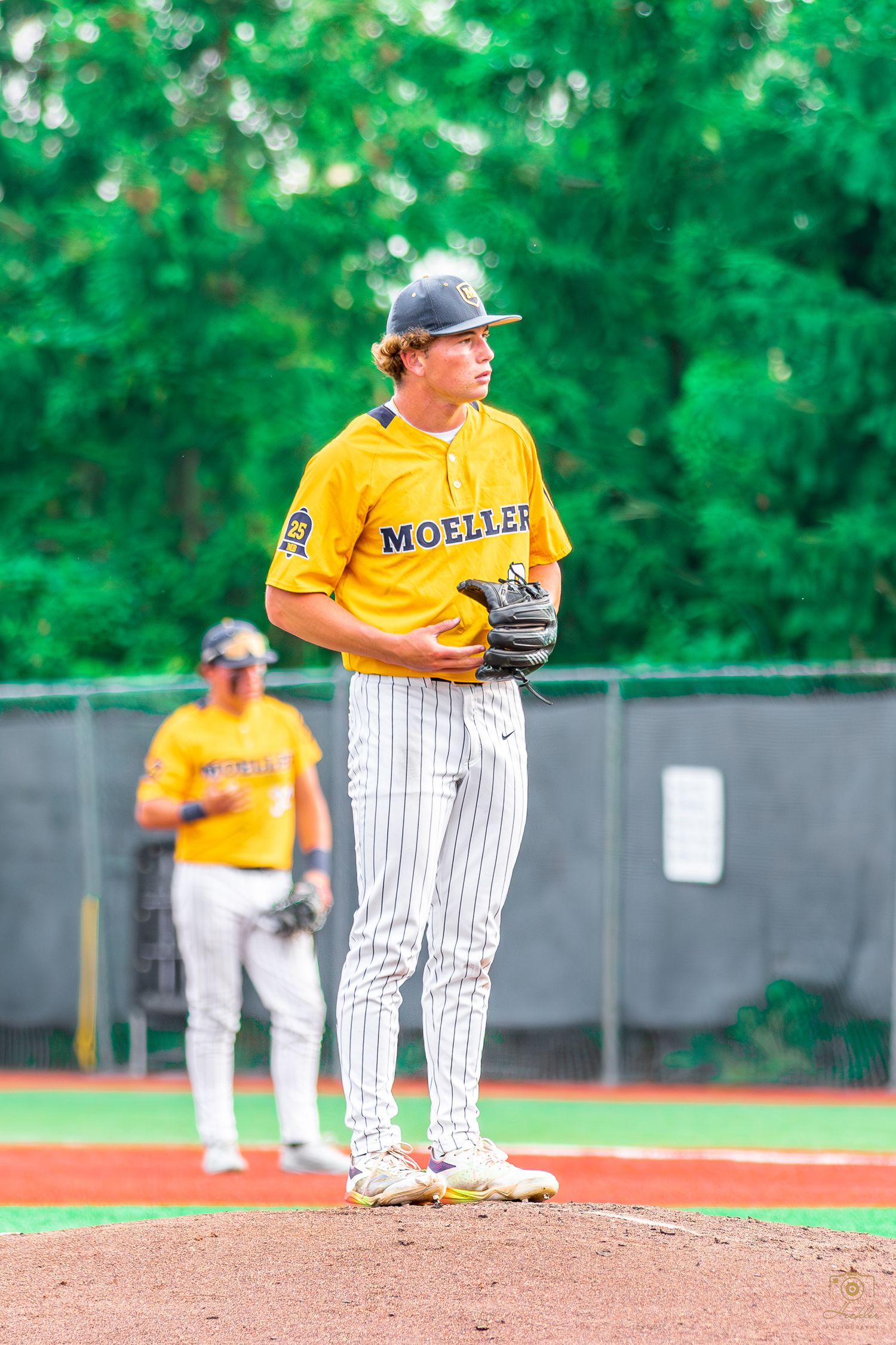 Baseball player about to pitch the ball.