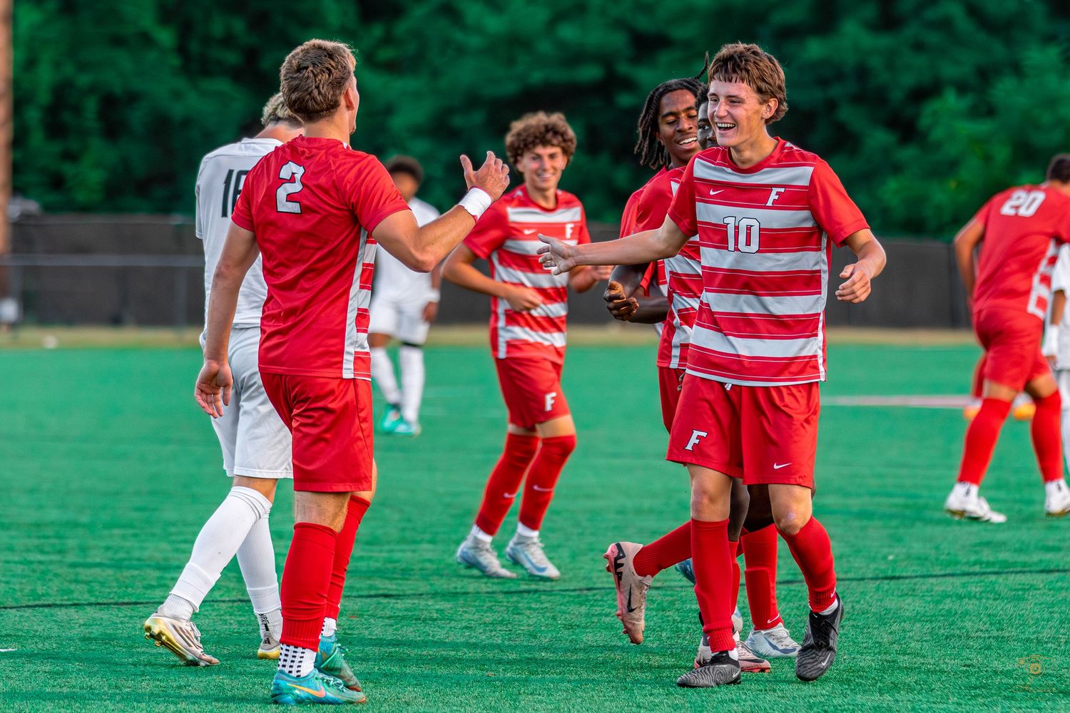 Soccer players celebrating after a goal.