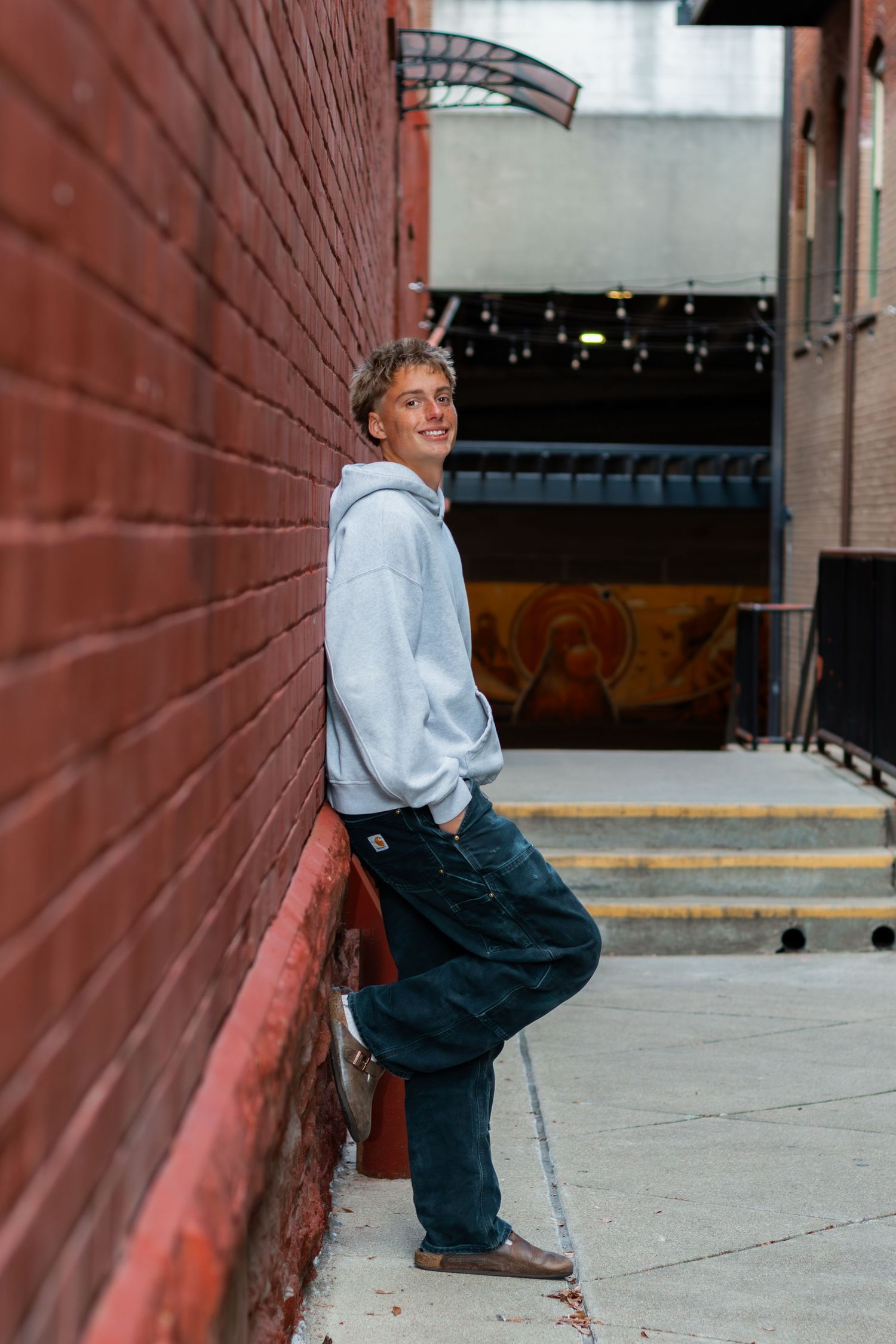 Senior smiling at camera in ally.
