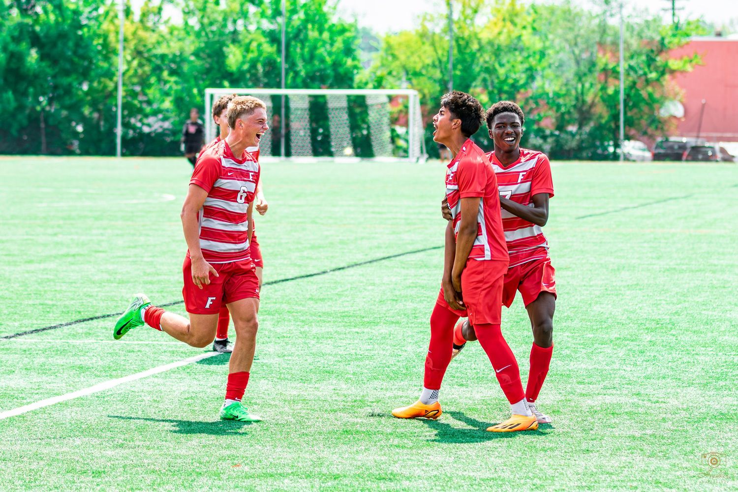 Soccer players celebrating with each other after a goal.