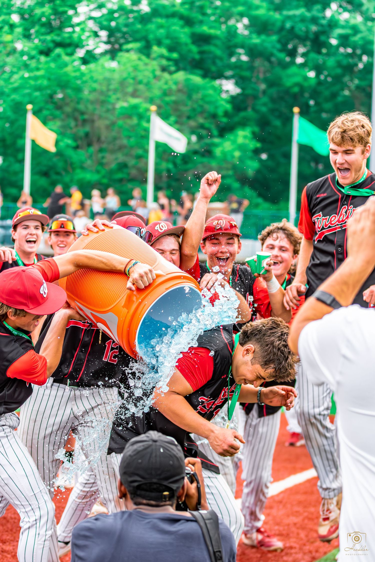 Baseball player getting Gatorade poured on them after big win.