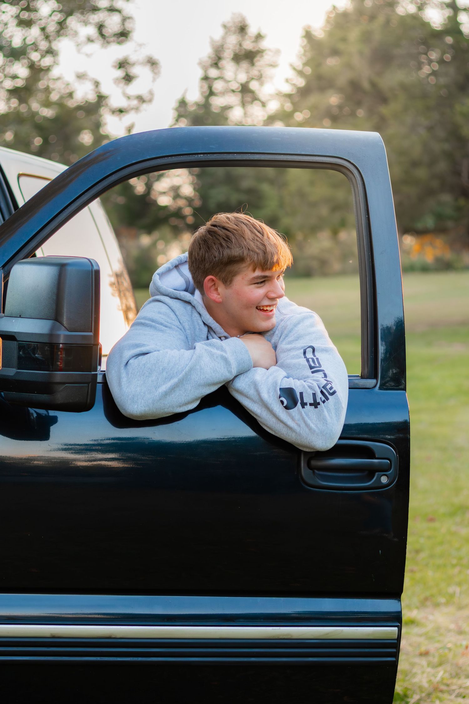 Senior looking out window while smiling.