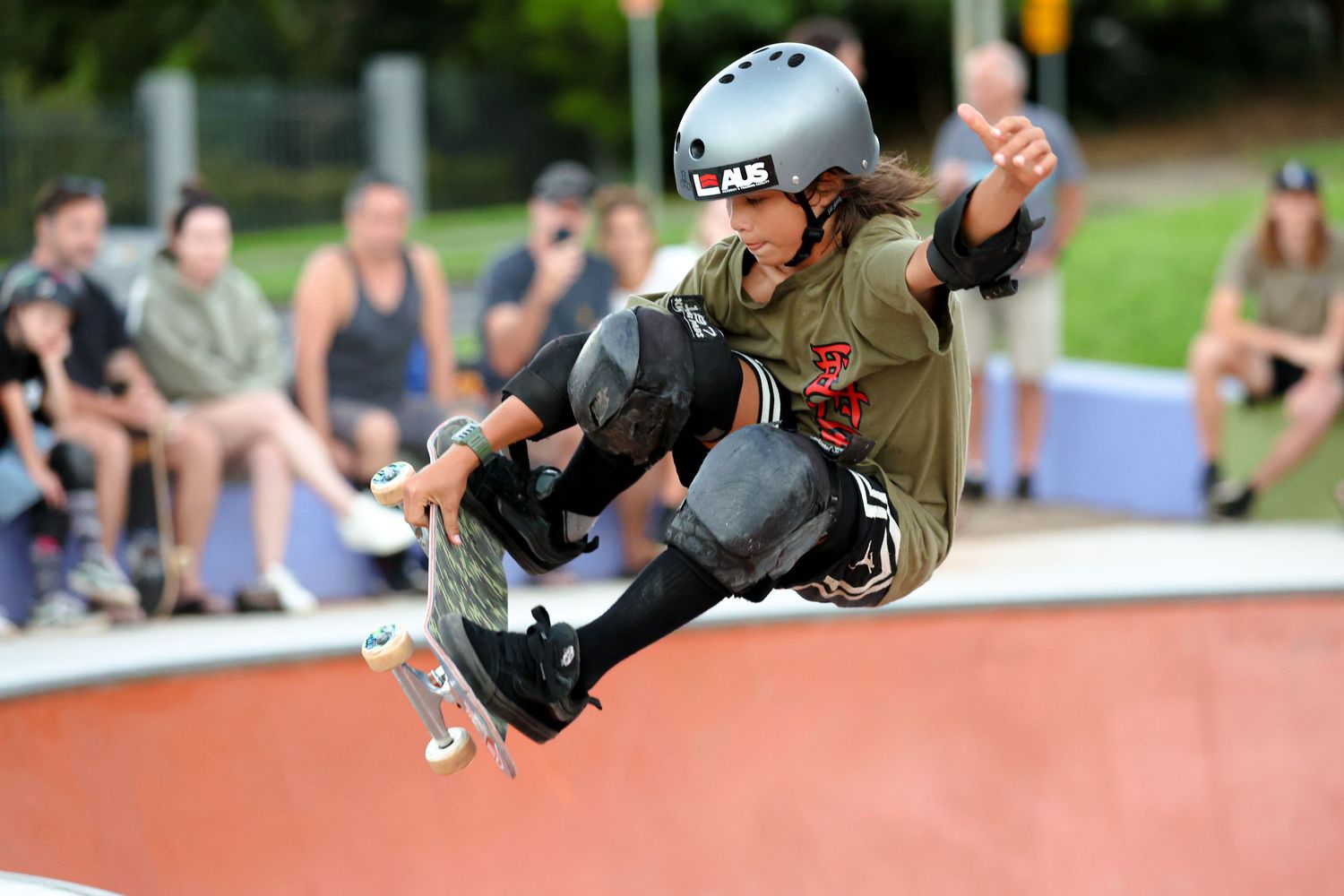 Athletes competing in track and field events on an outdoor sports field.