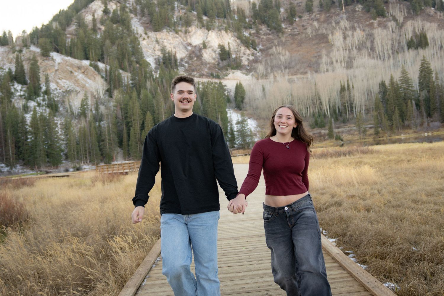 Utah mountain engagement photoshoot with couple smiling and holding hands