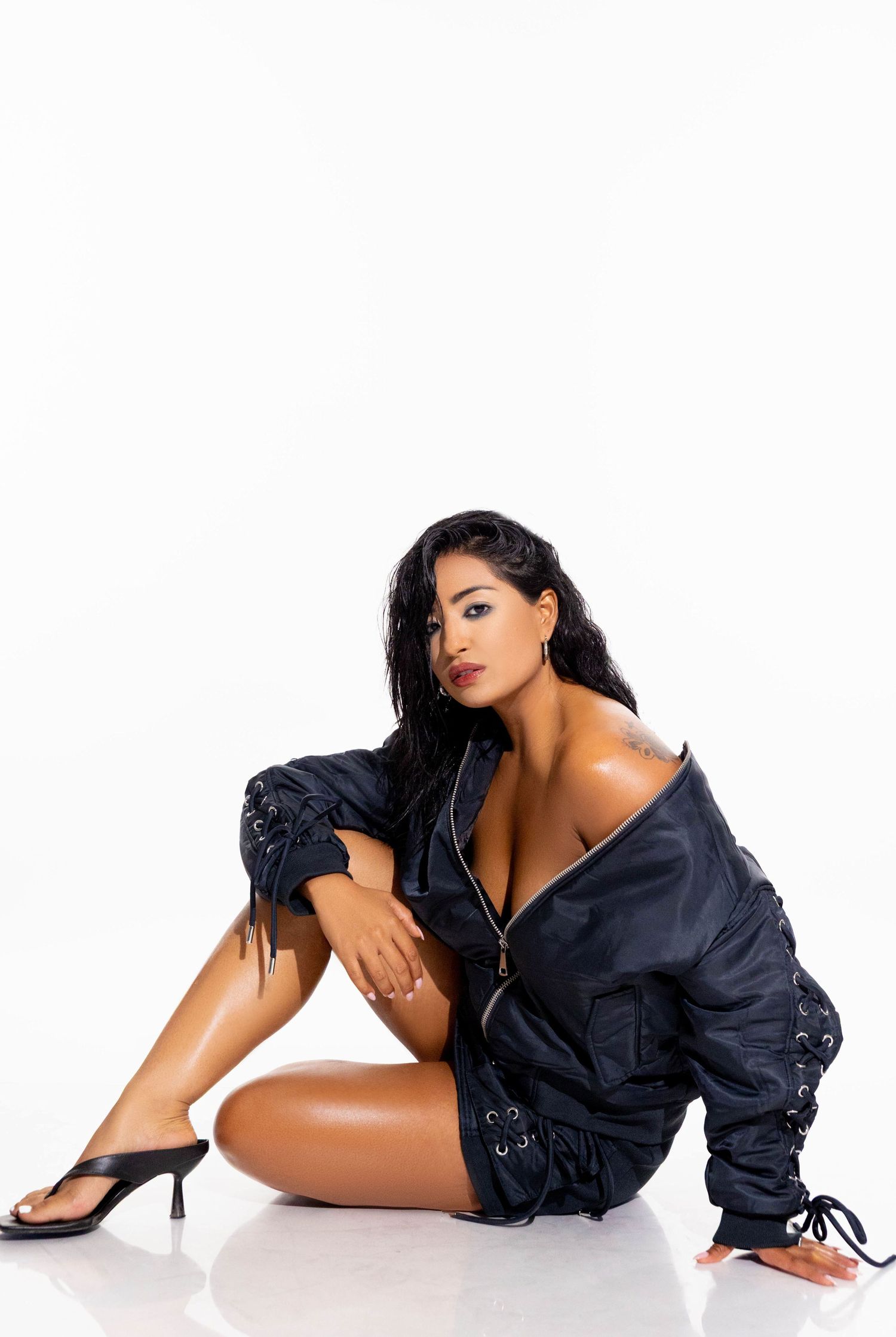 Model posing for a high-end fashion campaign wearing elegant designer clothing.