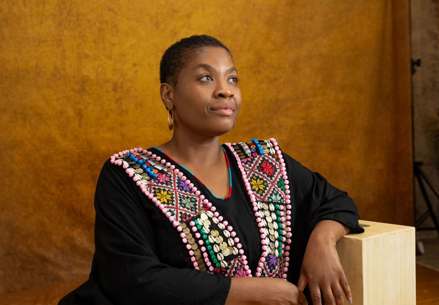 Portrait of a female business owner smiling while standing in her creative studio.