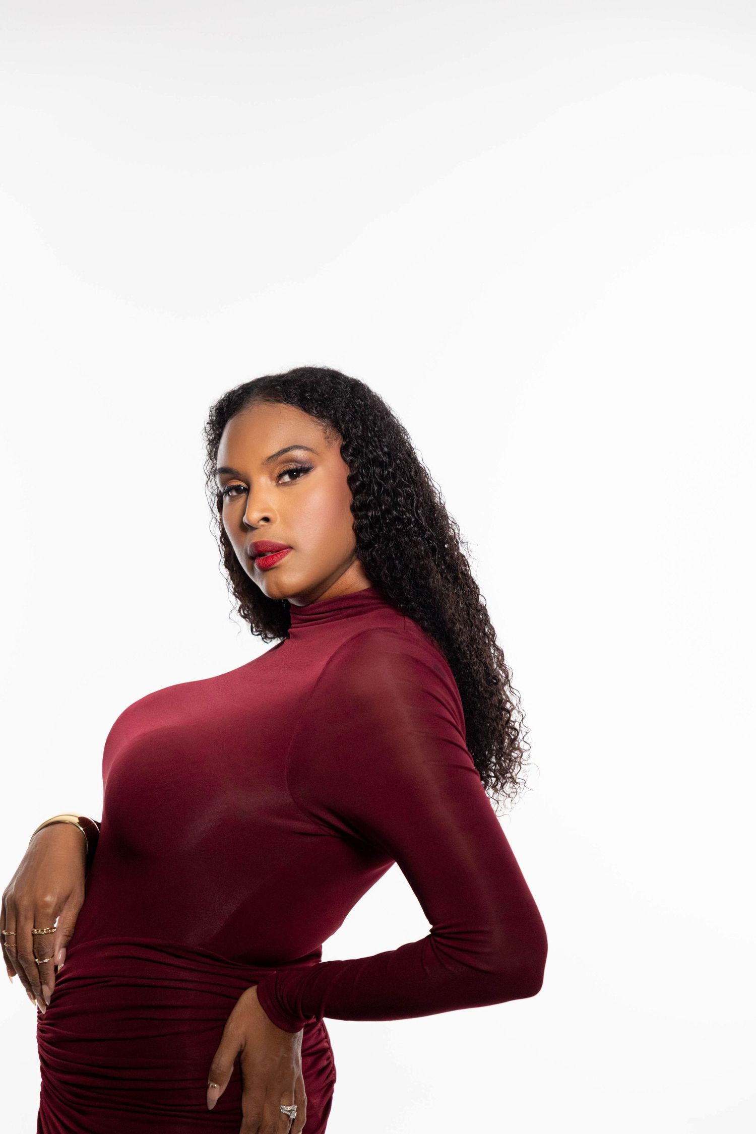 Fashion portrait of a woman showcasing a stylish outfit in a vibrant studio setting.
