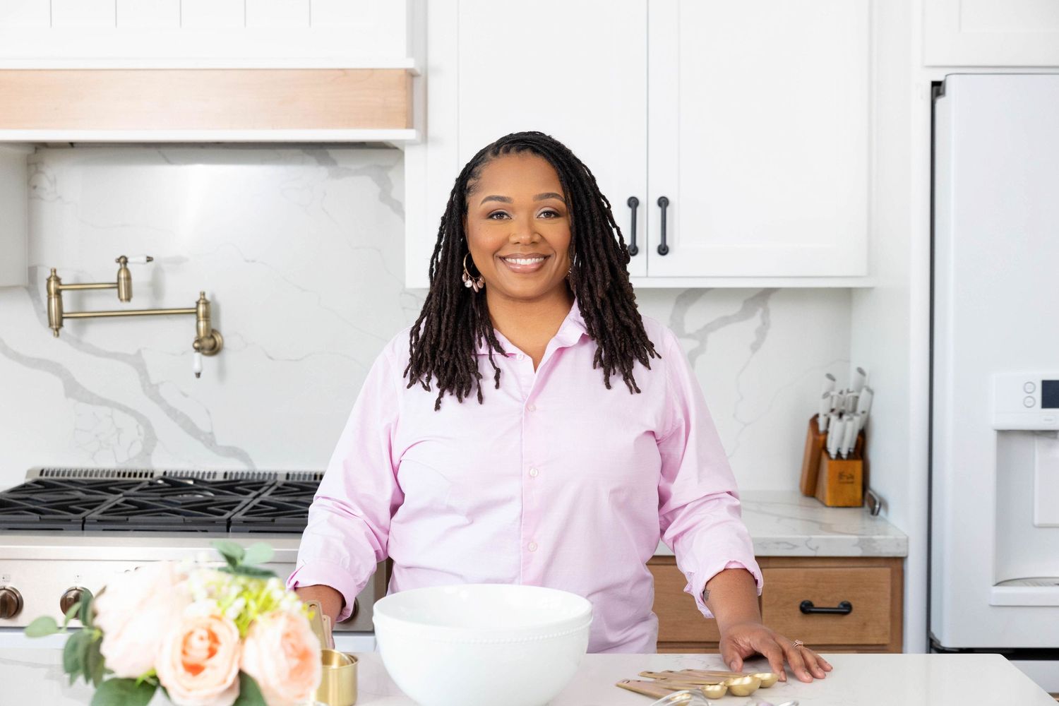 Portrait of a baker standing proudly in her kitchen prepping before she makes cookies.