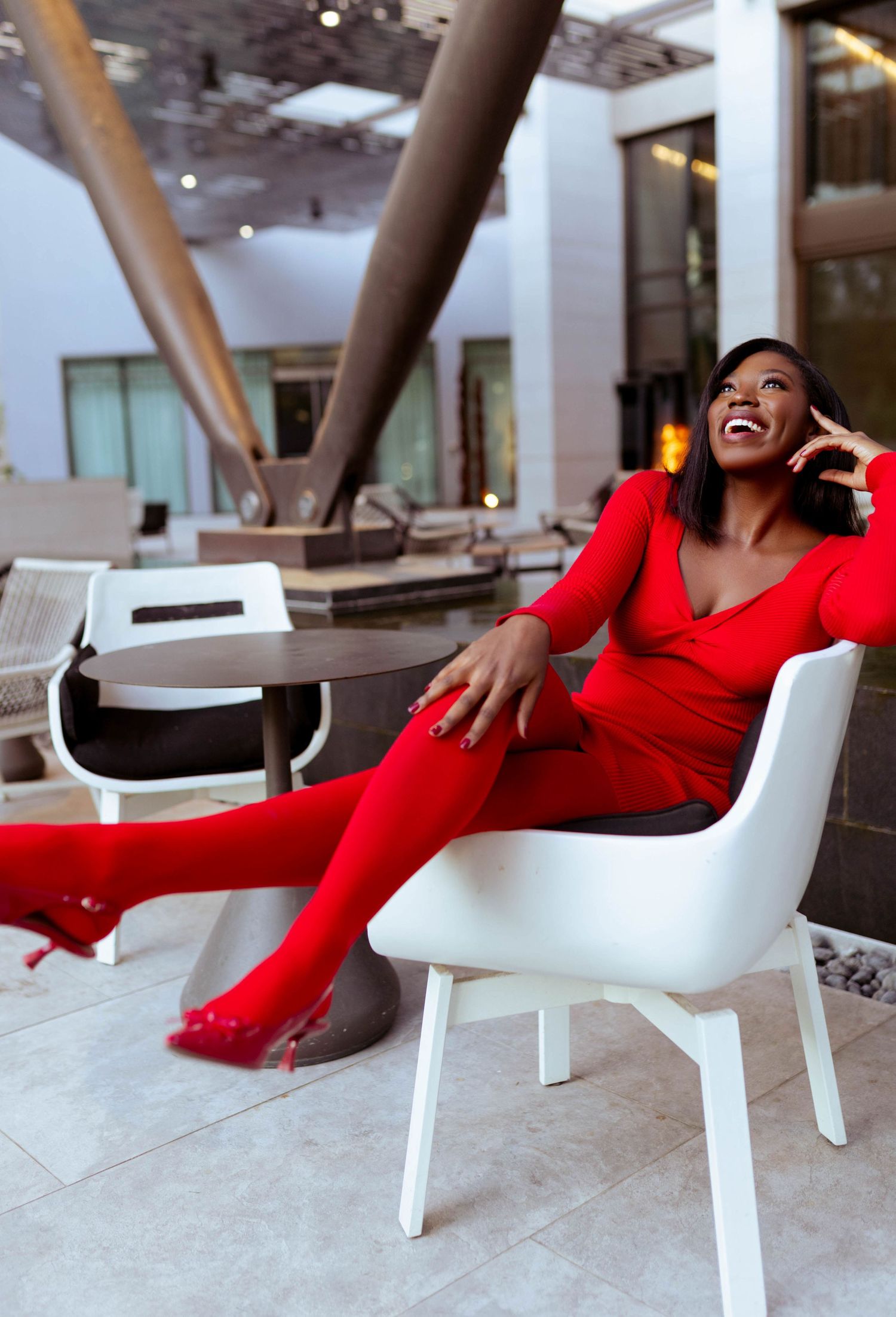 Fashion portrait of a woman showcasing a stylish outfit in a vibrant urban setting.