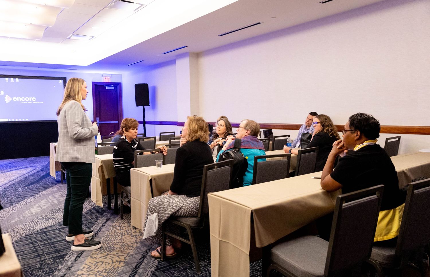 Attendees taking notes and engaging during a panel discussion at a business event.