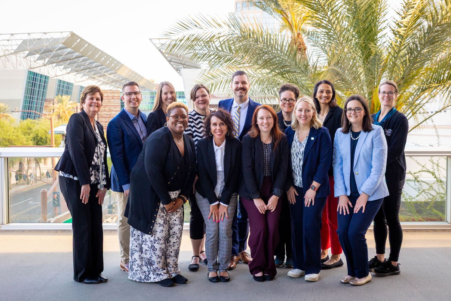 Professional group photo capturing smiling colleagues at a company event.