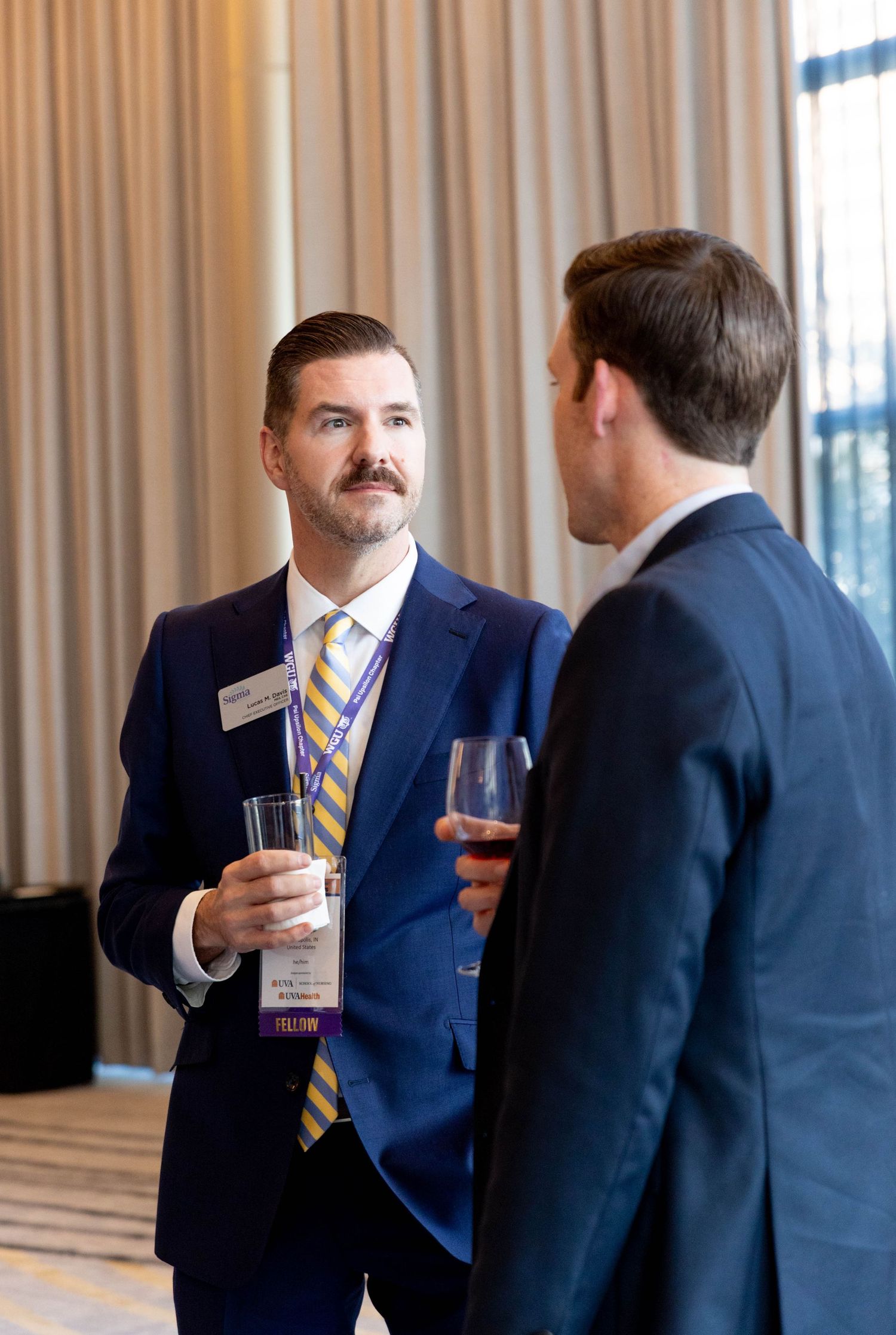 Business professionals networking and exchanging ideas during event breaks.