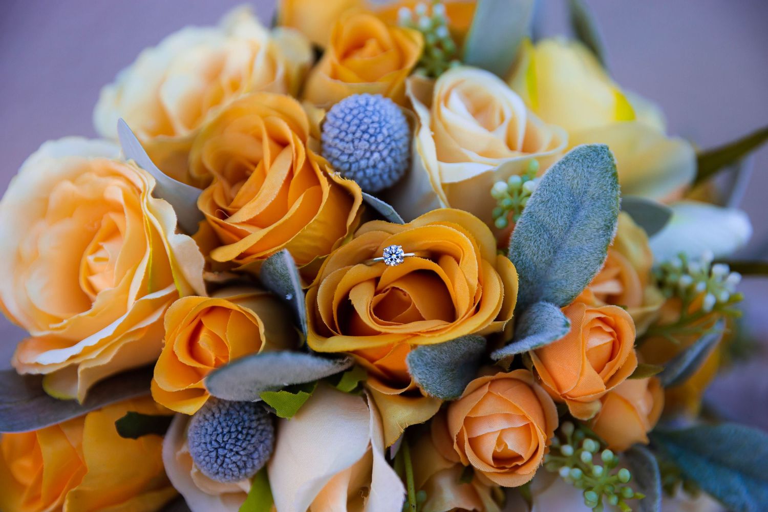 Close-up of engagement ring on a floral bouquet during a destination wedding