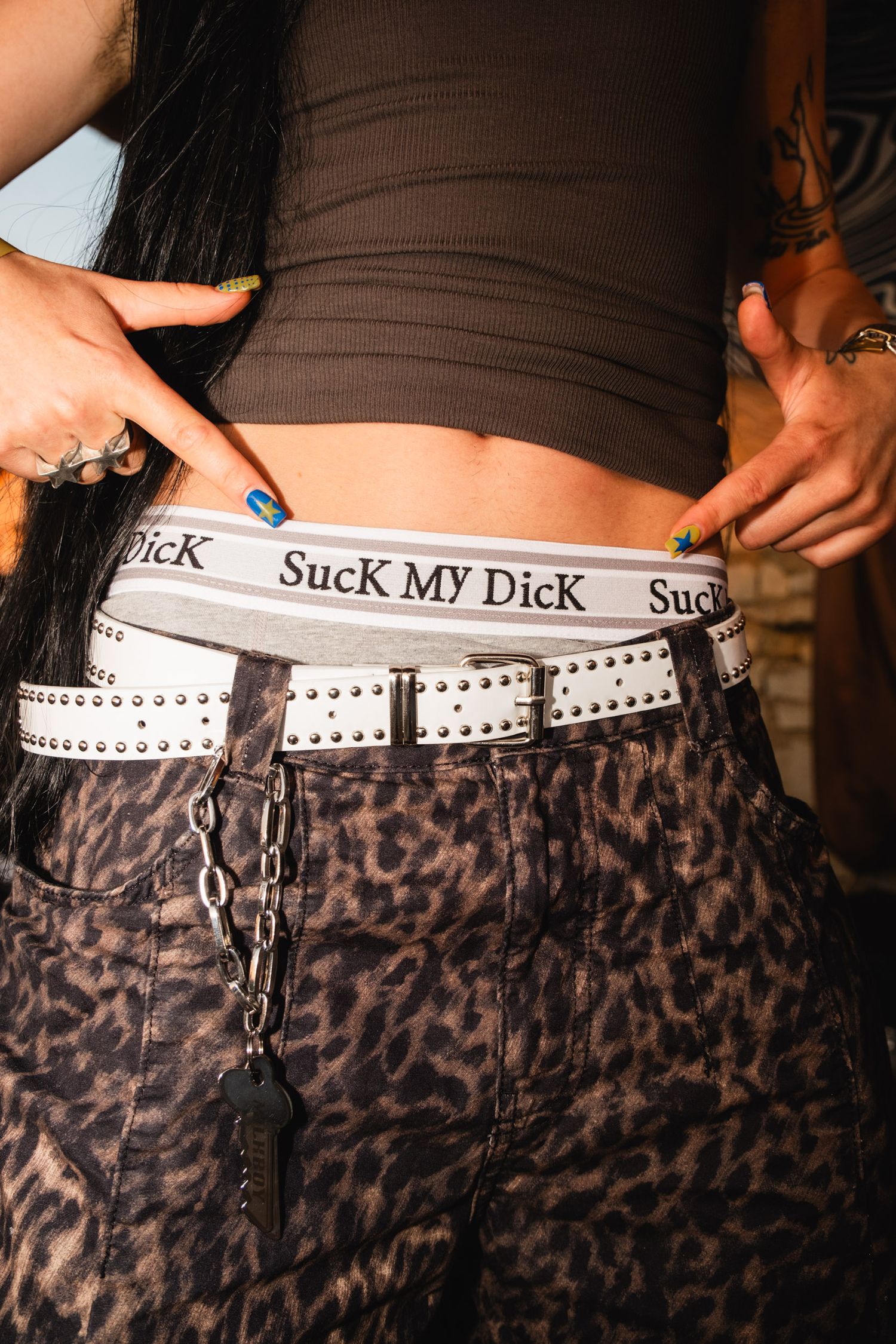 Close-up of leopard print pants with a white waistband detail.
