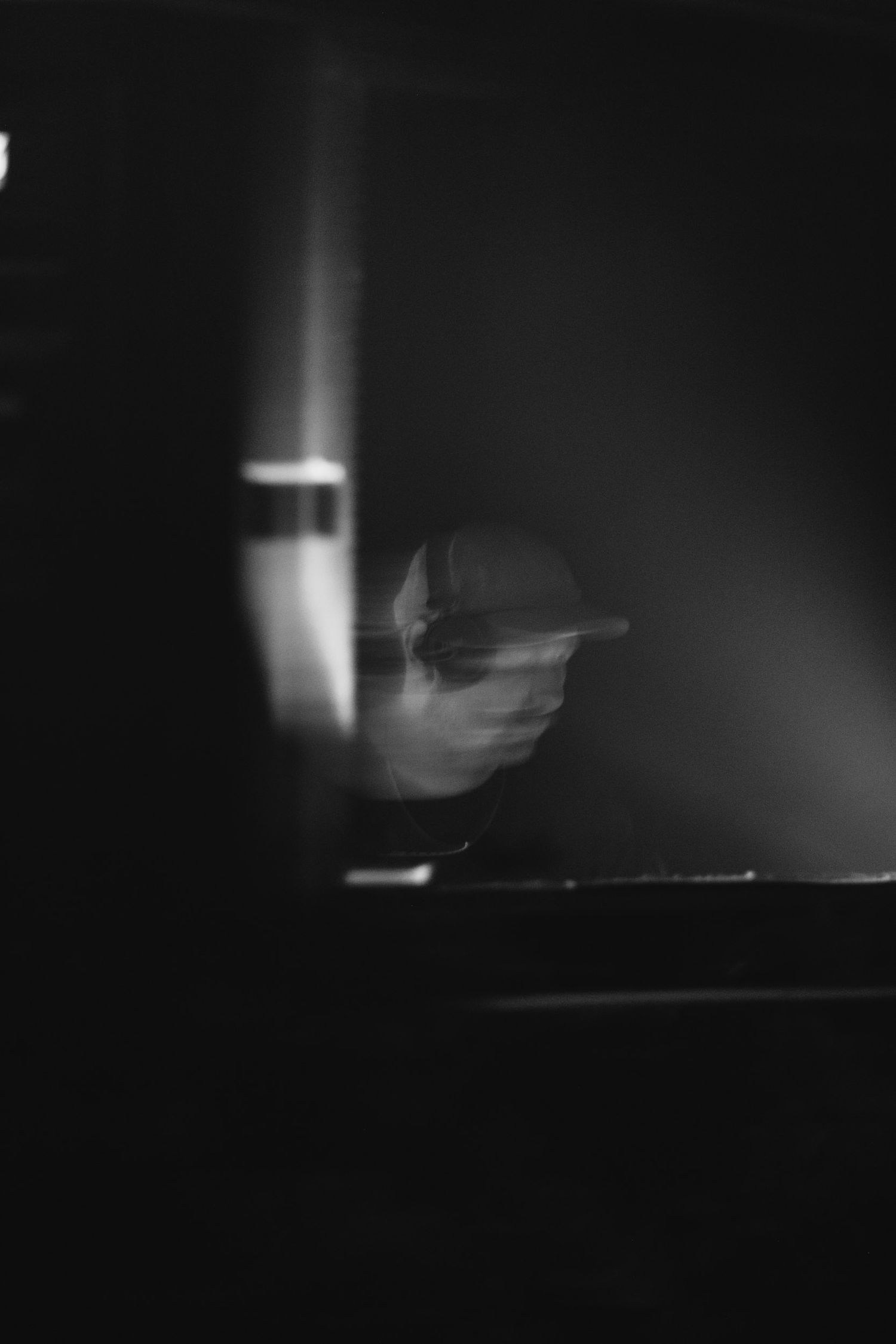 Minimalist black and white performance scene with dramatic lighting.