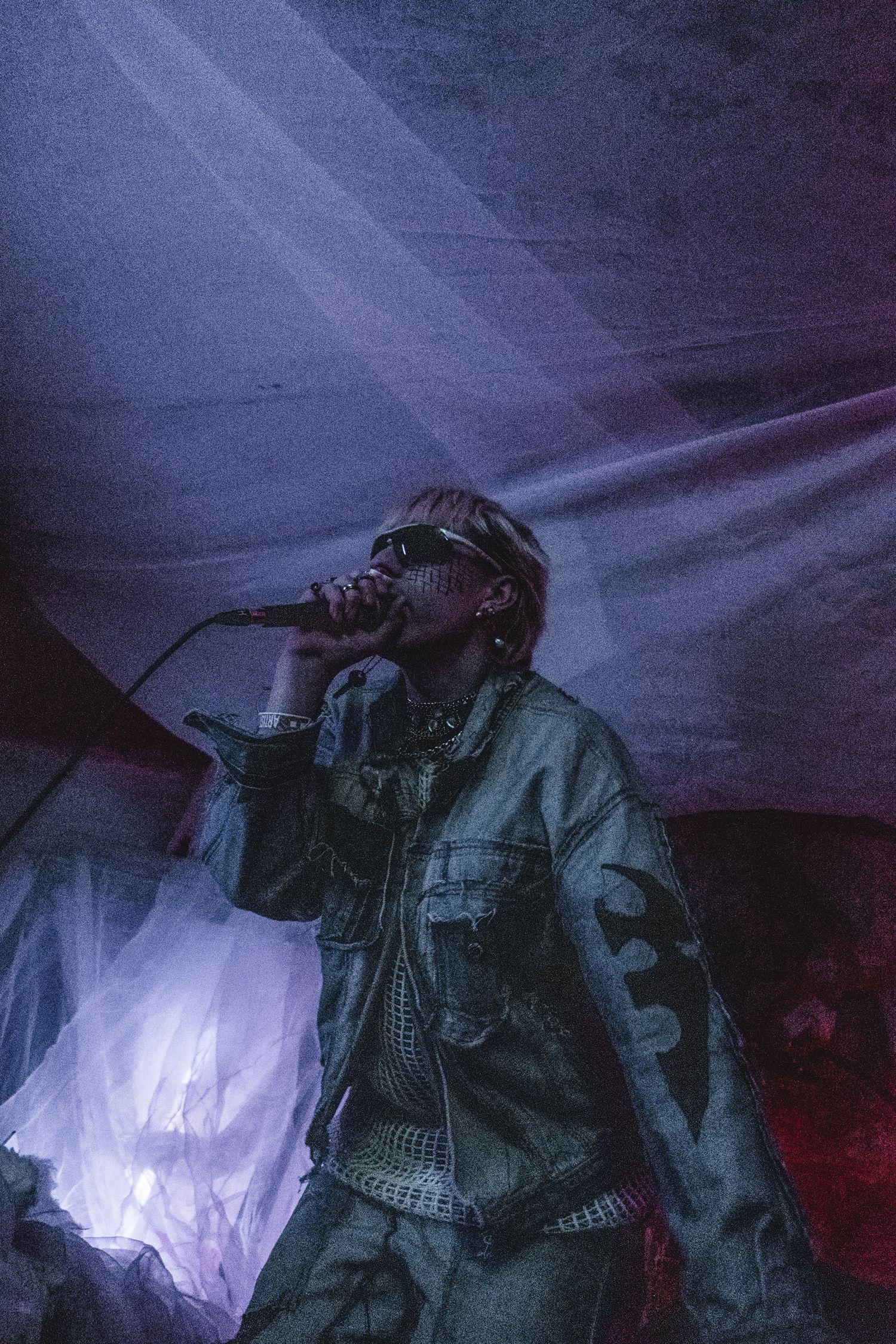 Figure in military-style gear illuminated by dramatic lighting effects.